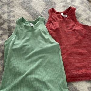 Athleta fitted  like new tanks. Worn a few times. Hem Hits at waist. $ 25/ tank